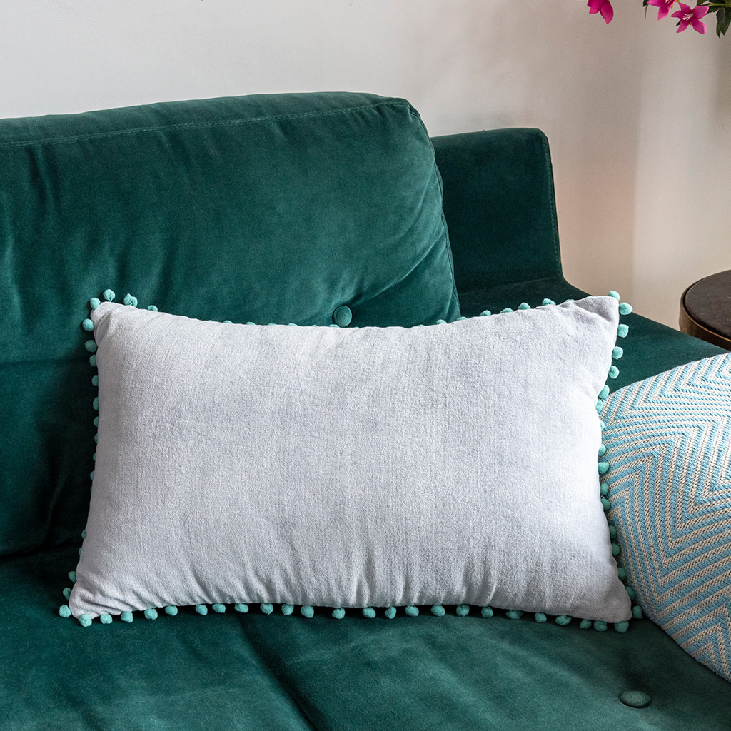 Grey cushion with pom poms hotsell