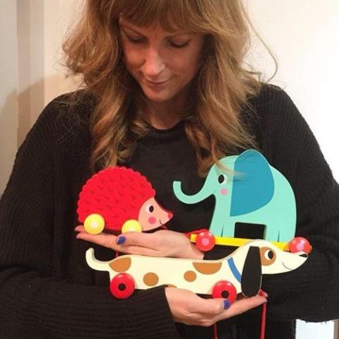 asa wikman with wooden pull toys