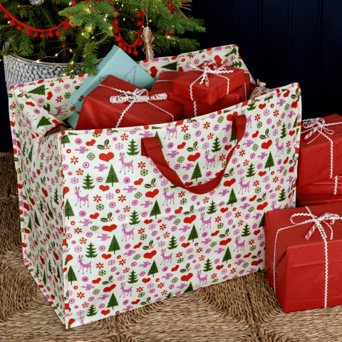 A festive jumbo bag with wrapped gifts poking out of the top