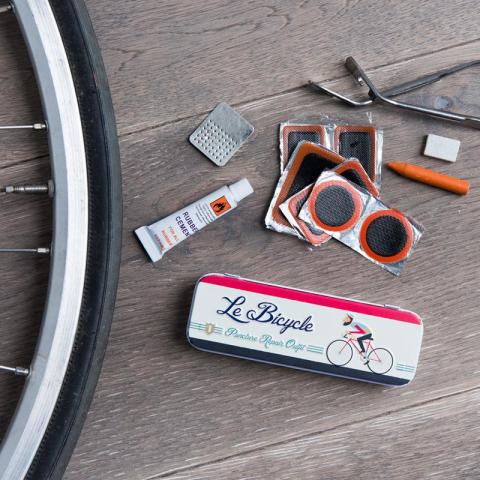 Bicycle puncture repair kit with wheel in picture