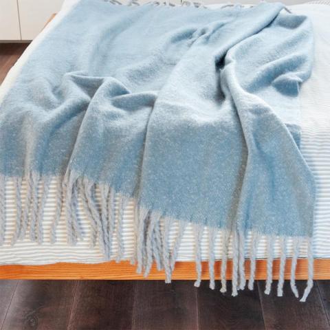 blue blanket with tassels