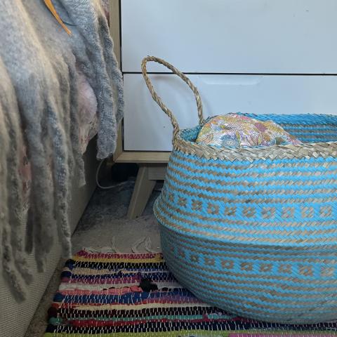 blue basket in bedroom