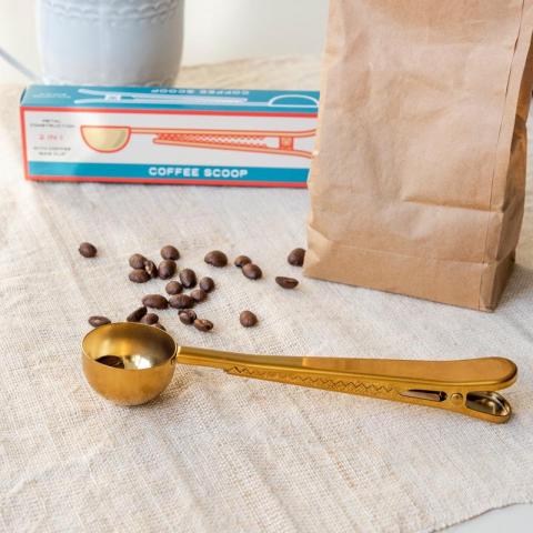 Golden coffee scoop with coffee bag