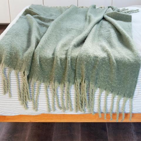 Green blanket with tassels