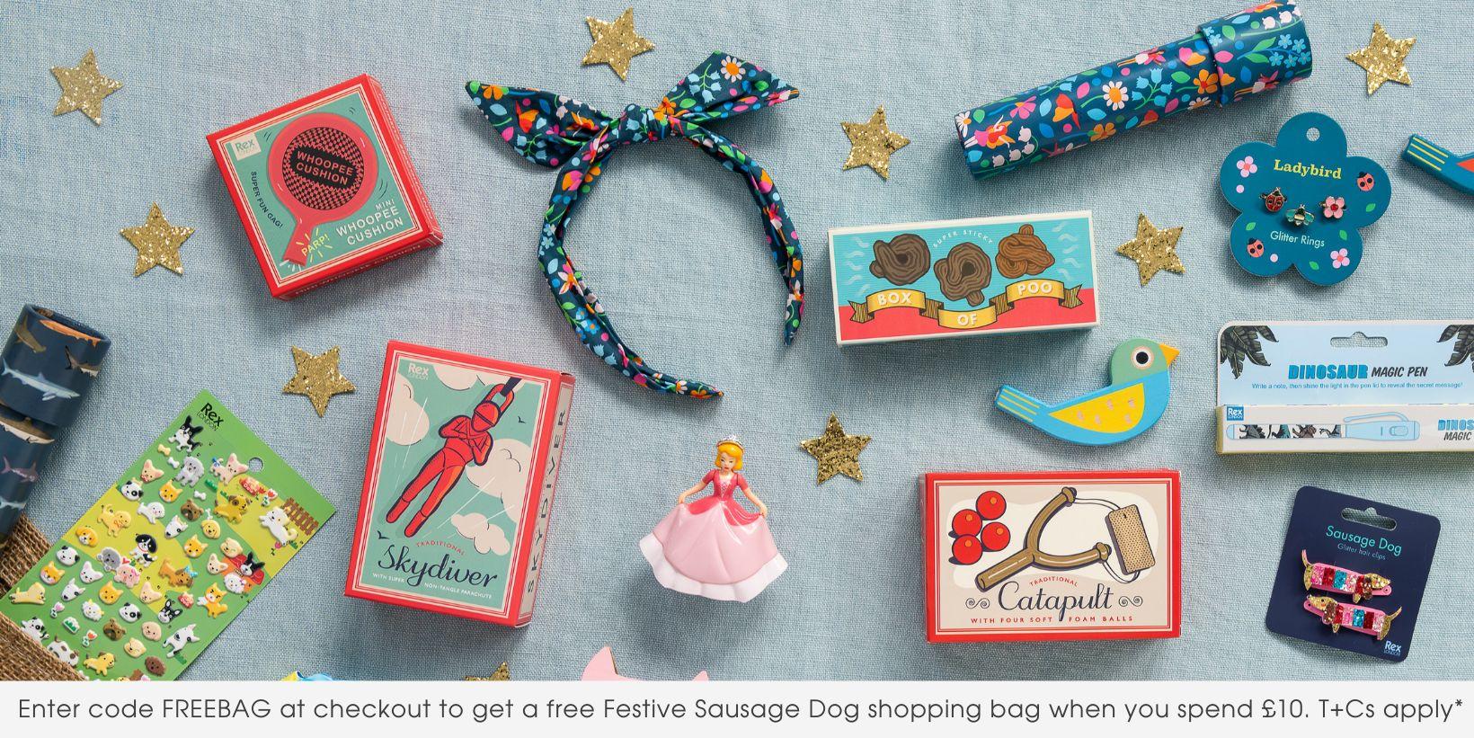 An array of stocking filler toys and games is spread out on a blue cloth