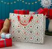 Christmas storage bag with classic designs, filled with presents
