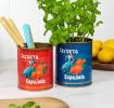 Two cerveza Española tins used as utensil holder and plant pot.