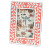 picture frame with a pink border and white leaf patterns