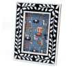 picture frame with a navy blue border and white leaf patterns