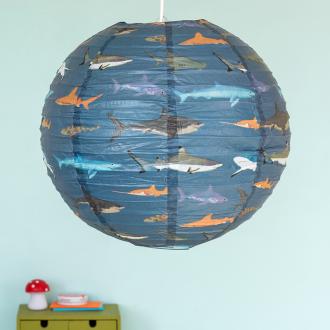 Dark blue paper lampshade with shark decoration installed in room