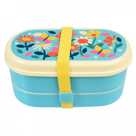 Light blue kids bento box with cream lid and middle tray plus yellow elastic strap featuring print of butterflies amongst flowers