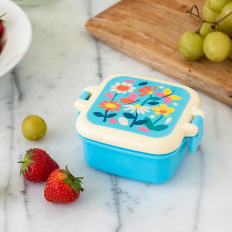 Light blue plastic snack pot with cream and light blue lid featuring print of butterflies amongst flowers