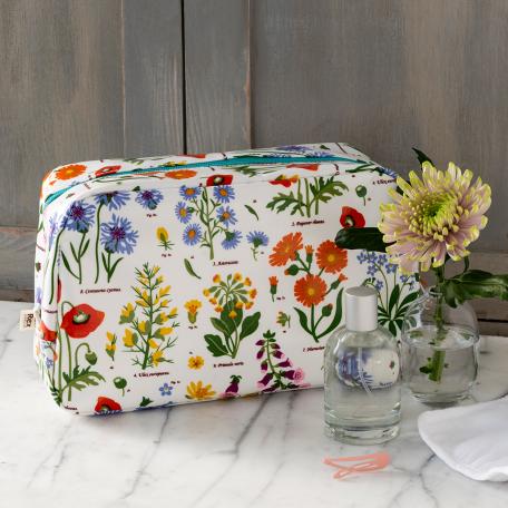 White oilcloth wash bag with wild flower pattern