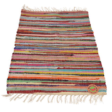 Multicoloured handloomed cotton rug laid flat with swing tag showing