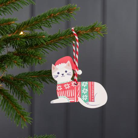 Wooden Christmas decoration of white cat wearing festive jumper and hat hanging on tree