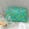 Turquoise oilcloth wash bag with print of cheetahs