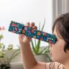 Child looking through dark blue kaleidoscope with print of fairies amongst flowers