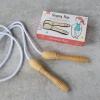 Traditional nylon skipping rope with wooden handles on ground with box