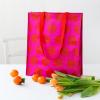 Recycled plastic shopping bag red circles pink background