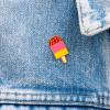 Ice lolly pin badge attached to piece of clothing