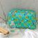 Turquoise oilcloth wash bag with print of cheetahs