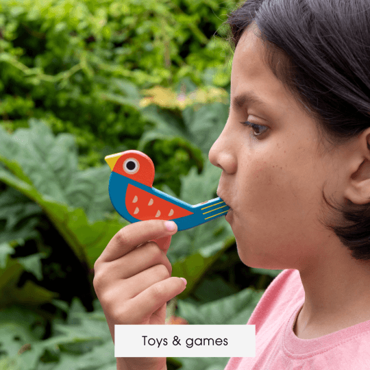 A child blows into a wooden bird whistle