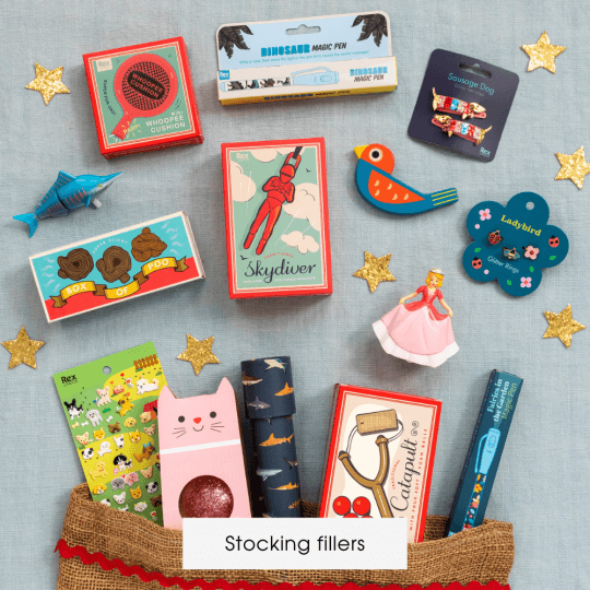 A selection of small toys and games spill out from a Christmas stocking