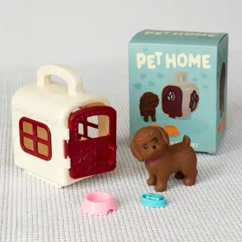 pet carrier with brown dog and a product box in the background